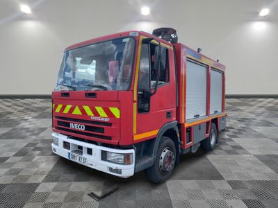 a red fire truck parked in a room with a checkered floor