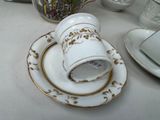 a cup and saucer sitting on a plate on a table