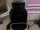a coffee maker that is sitting on the floor