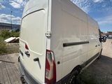 the back end of a white van parked in a parking lot