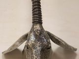 a metal animal head mounted on a wooden wall