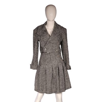 the mannequin is wearing a black and white checkered coat and dress