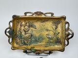 a gold plate with a picture of a woman playing a flute