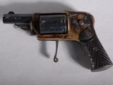 a toy gun that is sitting on a white surface