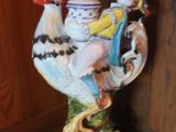 a figurine of a rooster on a table