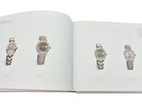 an open book with a bunch of different watches on it