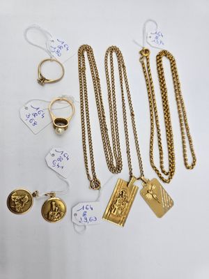 a close up of a bunch of gold jewelry on a table