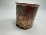a silver vase that is sitting on a table