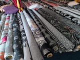 many rolls of fabric on a table in a room