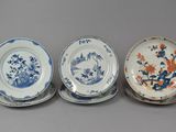 three blue and white plates with flowers and birds on them