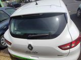 a white car with a green stripe parked in a parking lot