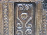 a close up of a wooden door with a skull on it