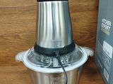 a silver blender sitting on a wooden table next to a box
