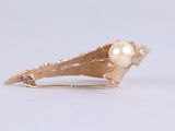 pearl in a shell broochle on a white background
