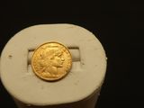 an image of a gold coin sitting on top of a white object