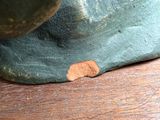 a close up of a statue of a person on a wooden table