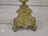 a gold lamp that is on a marble table