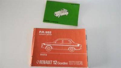 two books on the table with a car in the background