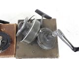 an old type of fishing reel and a box of old fishing reels