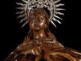 wooden statue of a woman with a crown on her head