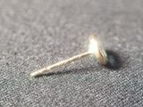 a close up of a small metal object on a cloth