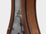a wooden grandfather clock with a glass case on it