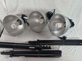 a group of three light bulbs and a tripod on a white background