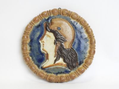 a picture of a ceramic plaque of a woman ' s face
