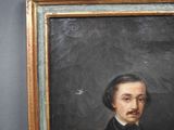 portrait of a man with a mustache in a black suit and bow tie