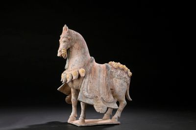 statue of a horse with a rider on it ' s back on a black background