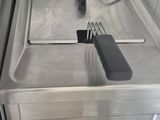 a kitchen with a stove, sink, and a dishwasher