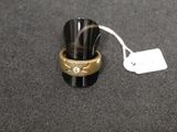 a ring with a diamond on it sitting next to a price tag