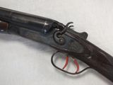 a close up of a gun on a table with a white background