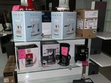 many boxes of coffee on a shelf in a store