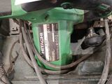 a close up of a green drill on the ground