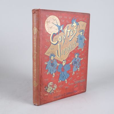 un vieux livre rouge orné de lettres dorées, posé sur une surface blanche