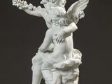 an image of a statue of an angel sitting on top of a rock