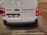 a white van that is parked in a parking lot