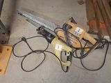 a picture of a chainsaw sitting on the floor next to a pile of wood
