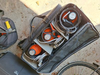 a suitcase with various items in it on the ground