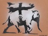painting of an elephant with a cross on it ' s back walking down a street