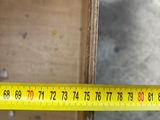 a measuring tape that is on the side of a piece of wood