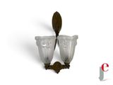 two wall sconces that are on the wall