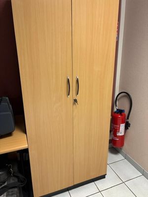 une armoire située dans un coin de la pièce et équipée d'un extincteur