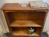 a wooden book shelf with a book on top of it