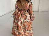 an image of a doll wearing a straw hat and dress