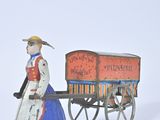 a figurine of a woman pulling a wagon with a dog
