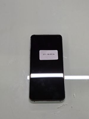 a black cell phone with a sticker on it