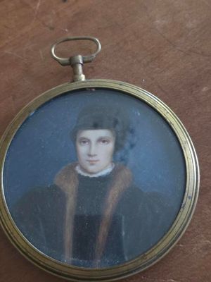 a miniature picture of a man in a black coat