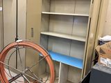 a large metal cabinet with a hose on a cart